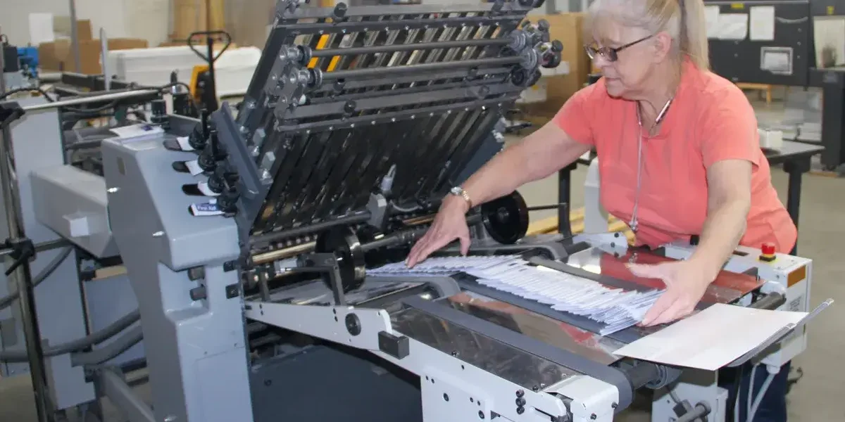 The Mid-York Press employee using printing machine